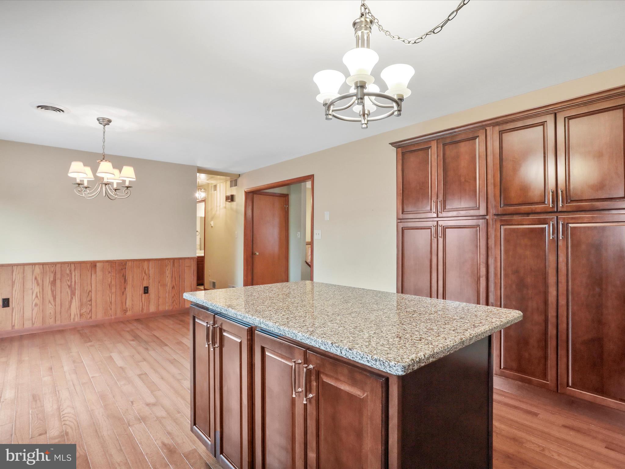 47 Diffys Drive Shippensburg, PA 17257 - Photo 7 of 48 a kitchen with kitchen island granite countertop wooden floors and refrigerator