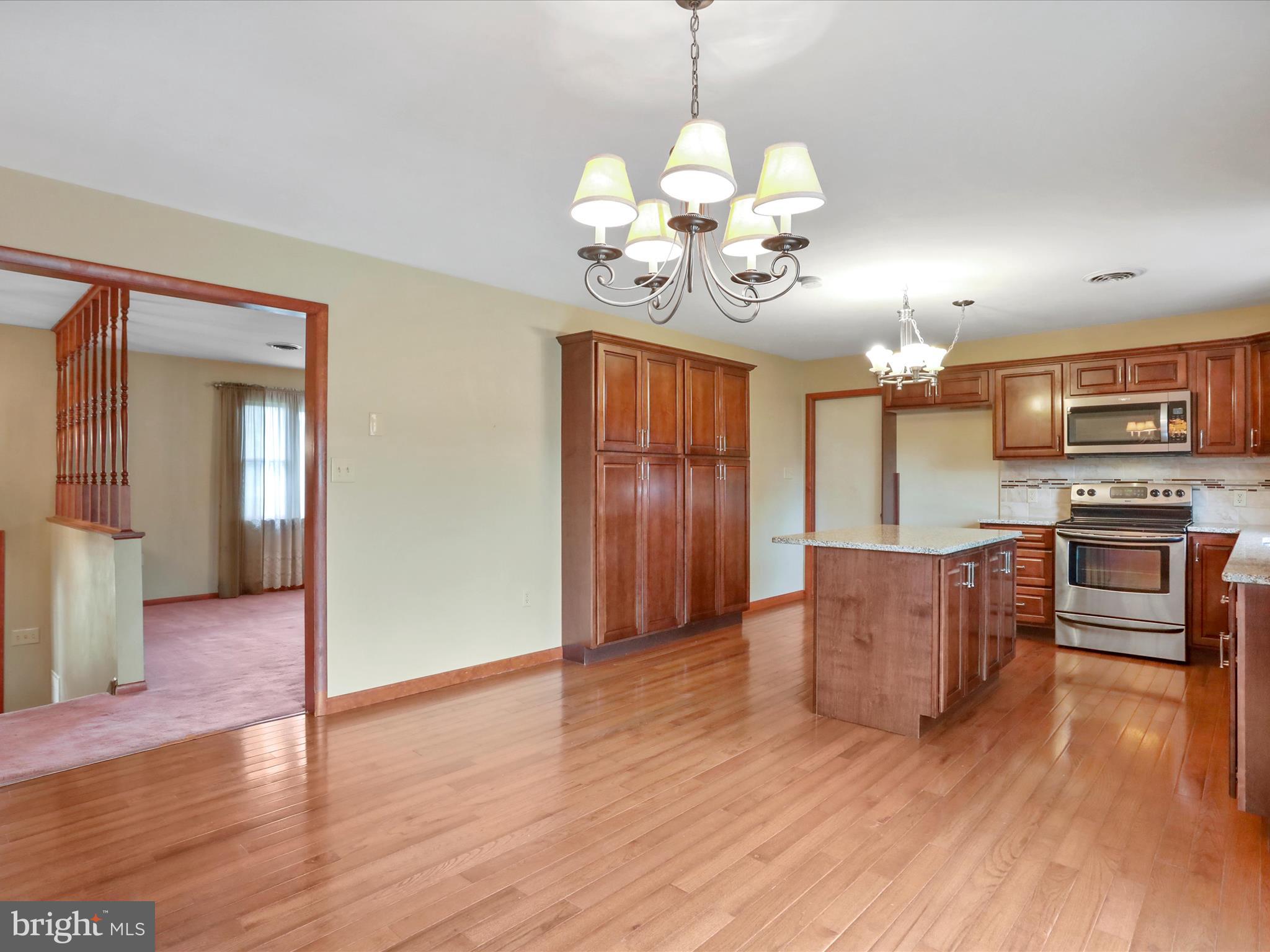 47 Diffys Drive Shippensburg, PA 17257 - Photo 9 of 48 a view of kitchen with granite countertop stainless steel appliances and wooden floor