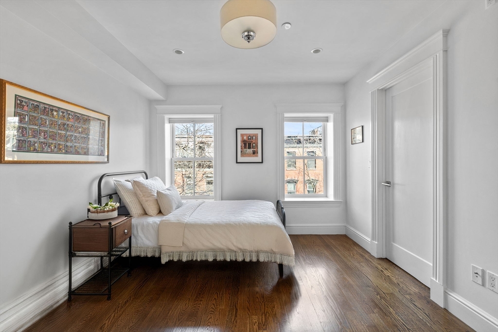 34 Dwight Street, Unit 2 Boston, MA 02118 - Photo 13 of 22 a spacious bedroom with a bed and wooden floor