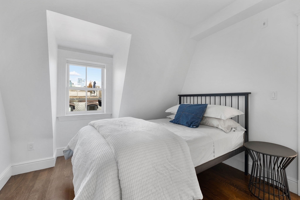34 Dwight Street, Unit 2 Boston, MA 02118 - Photo 15 of 22 a bedroom with a bed and wooden floor