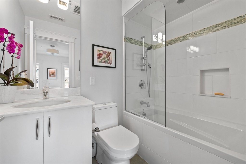 34 Dwight Street, Unit 2 Boston, MA 02118 - Photo 16 of 22 a bathroom with a sink toilet vanity and shower
