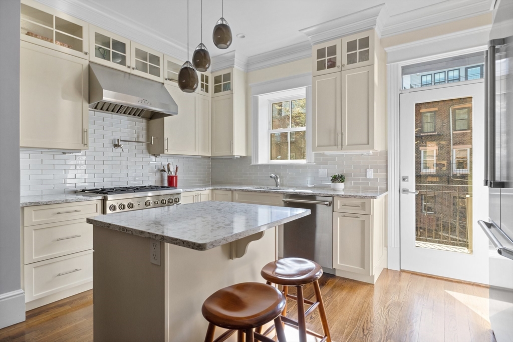 34 Dwight Street, Unit 2 Boston, MA 02118 - Photo 3 of 22 a kitchen with a sink cabinets and wooden floor