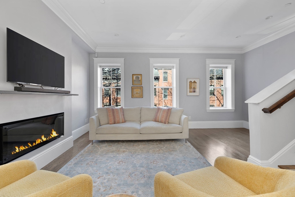 34 Dwight Street, Unit 2 Boston, MA 02118 - Photo 8 of 22 a living room with furniture flat screen tv and a fireplace