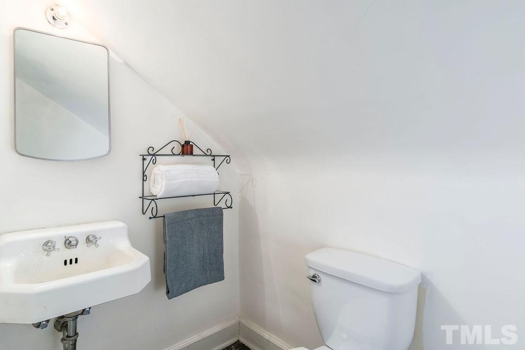 510 Harding Street Raleigh, NC 27604 - Photo 20 of 30 a bathroom with a sink toilet and mirror