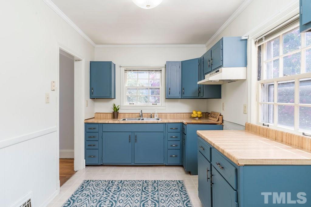 510 Harding Street Raleigh, NC 27604 - Photo 9 of 30 a kitchen with stainless steel appliances granite countertop a sink and a stove
