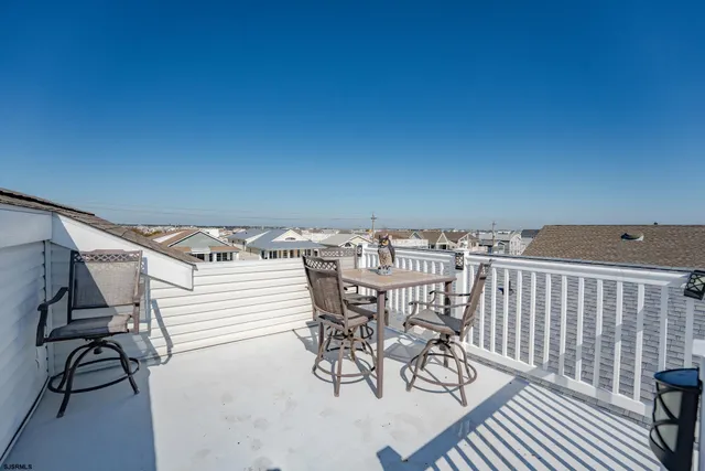 a view of a terrace with furniture and wooden floor