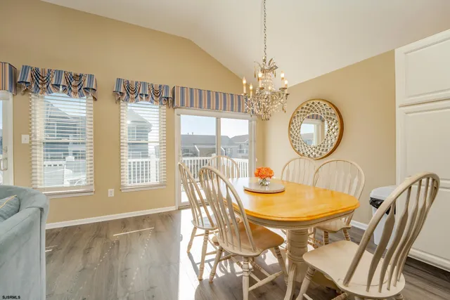 a view of a dining room with furniture and chandelier