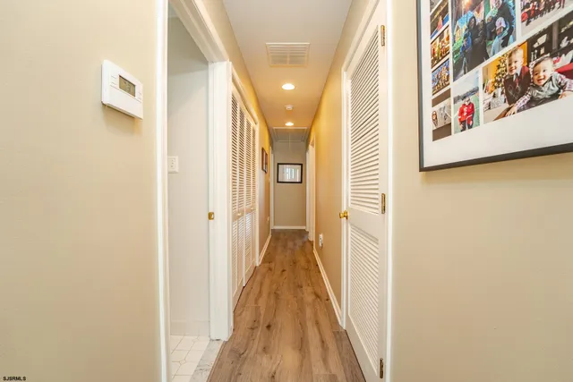 a view of a hallway with paintings on the wall