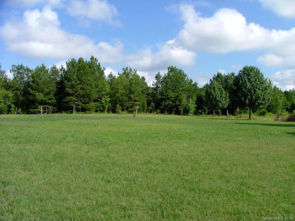 514 Billy Howey Road Waxhaw, NC 28173 - Photo 1 of 8 a backyard of a house with lots of green space and trampoline
