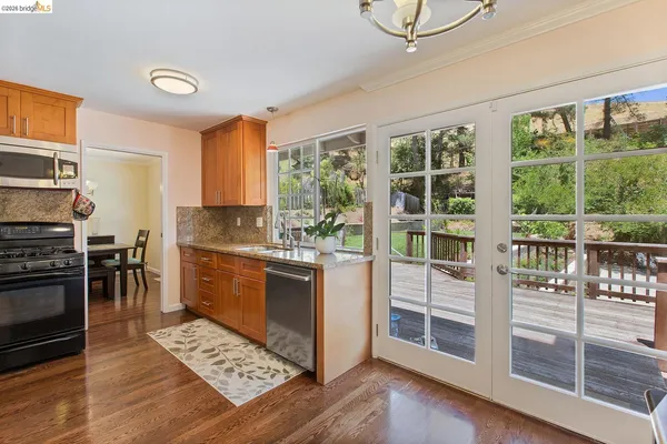 a kitchen with stainless steel appliances granite countertop a stove and a sink