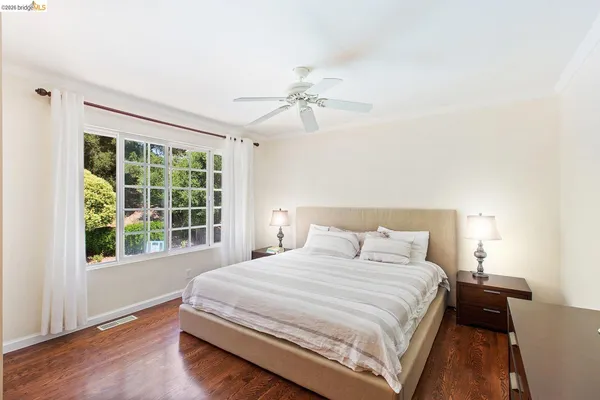 a bedroom with a large bed and a window