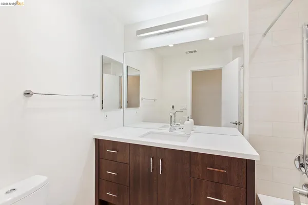 a bathroom with a sink vanity and mirror