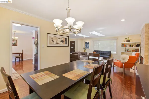 a view of a dining room with furniture wooden floor and chandelier