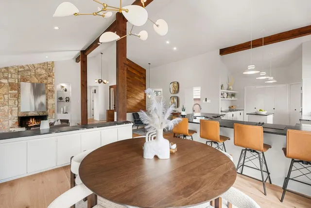 a dining room with large glass table and chairs