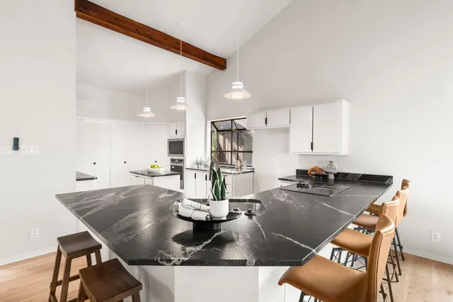 a kitchen with a table chairs and stove