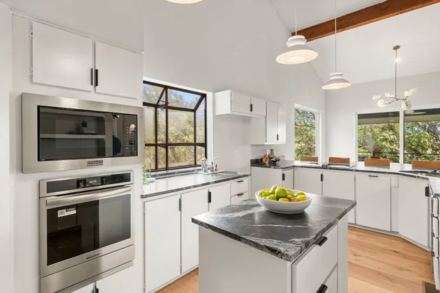 a kitchen with a stove a sink and a microwave
