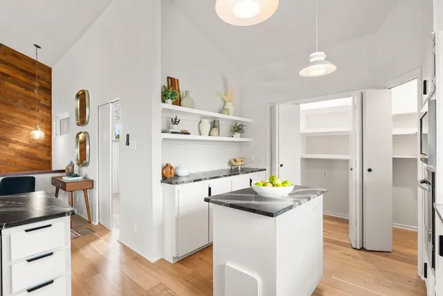 a kitchen with a sink cabinets and wooden floor