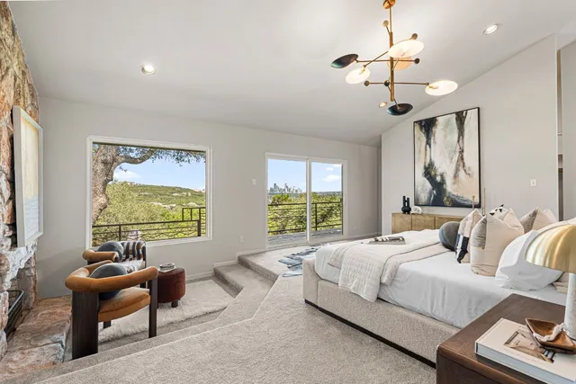 a bedroom with furniture and a large window