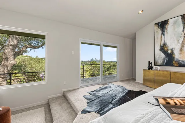 a bedroom with a large bed and a window