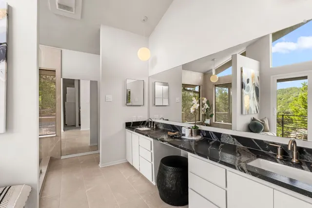a kitchen with granite countertop a sink and a refrigerator