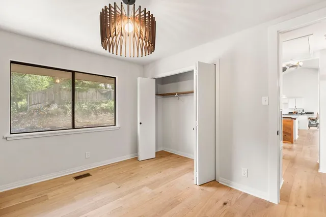 an empty room with windows and outdoor view