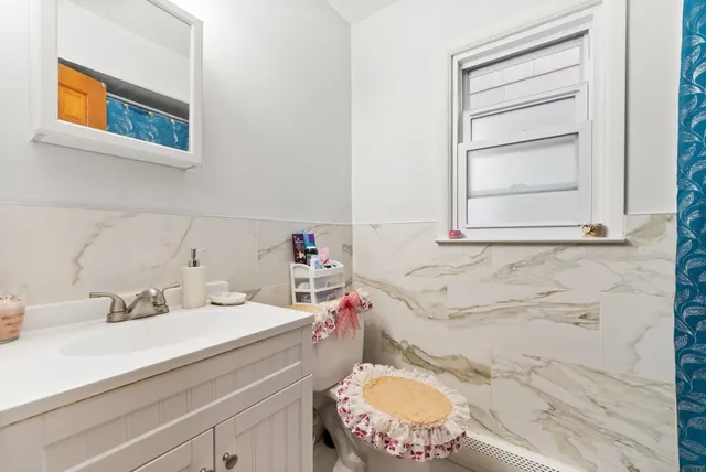 a bathroom with a sink toilet vanity and tub