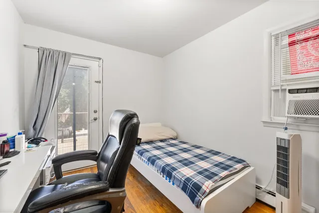 a bedroom with a bed and a window