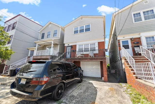 a car parked in front of a white building