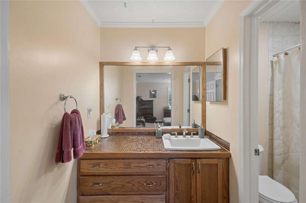 1382 Brockett Place Clarkston, GA 30021 - Photo 13 of 17 a bathroom with a granite countertop sink and a mirror
