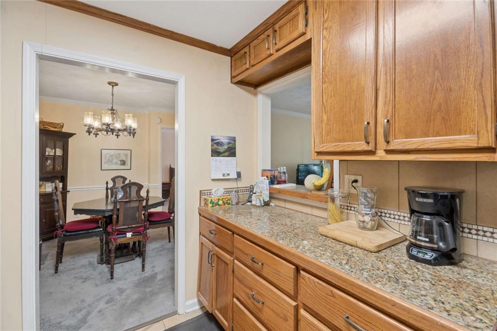 1382 Brockett Place Clarkston, GA 30021 - Photo 7 of 17 a kitchen with granite countertop a sink and a stove top oven