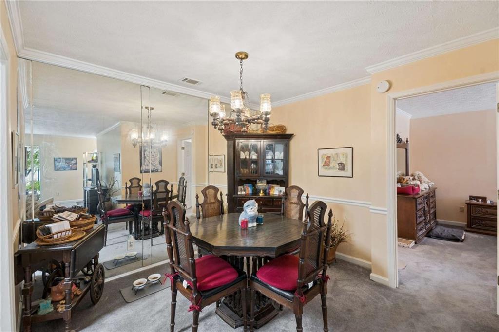 1382 Brockett Place Clarkston, GA 30021 - Photo 8 of 17 a view of a dining room with furniture and chandelier