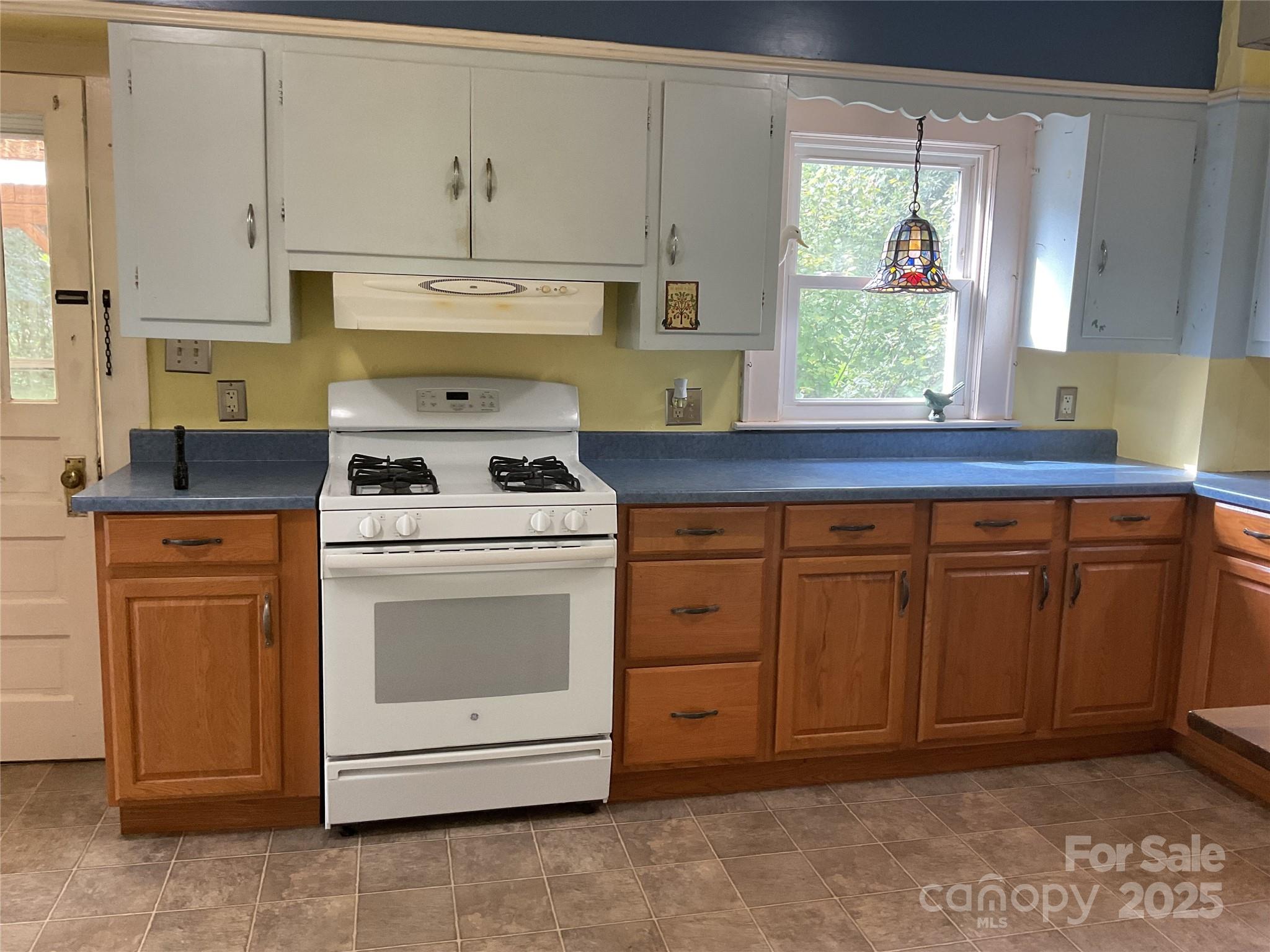 402 Connelly Springs Road Lenoir, NC 28645 - Photo 12 of 33 a kitchen with cabinets appliances and a window