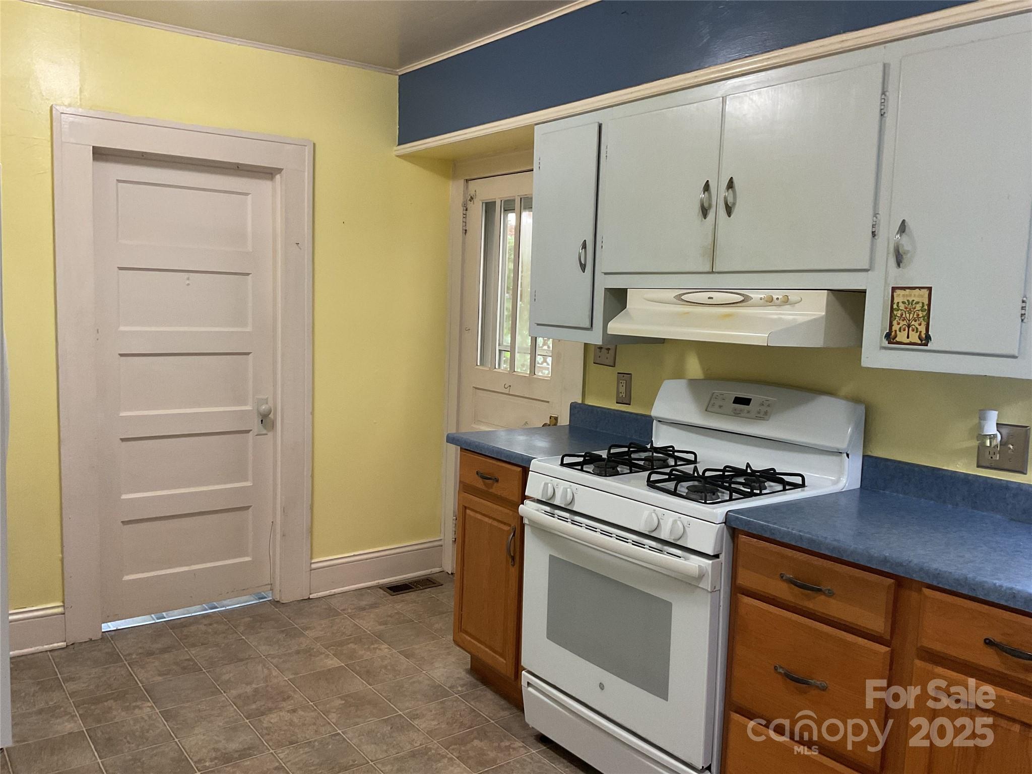 402 Connelly Springs Road Lenoir, NC 28645 - Photo 13 of 33 a kitchen with white cabinets and white appliances