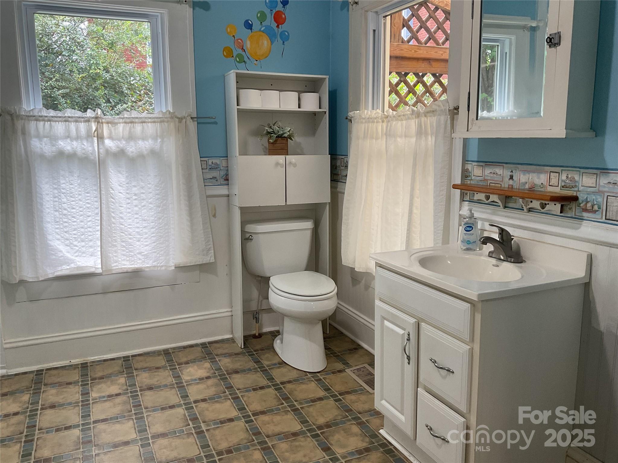 402 Connelly Springs Road Lenoir, NC 28645 - Photo 17 of 33 a bathroom with a sink a toilet and a window
