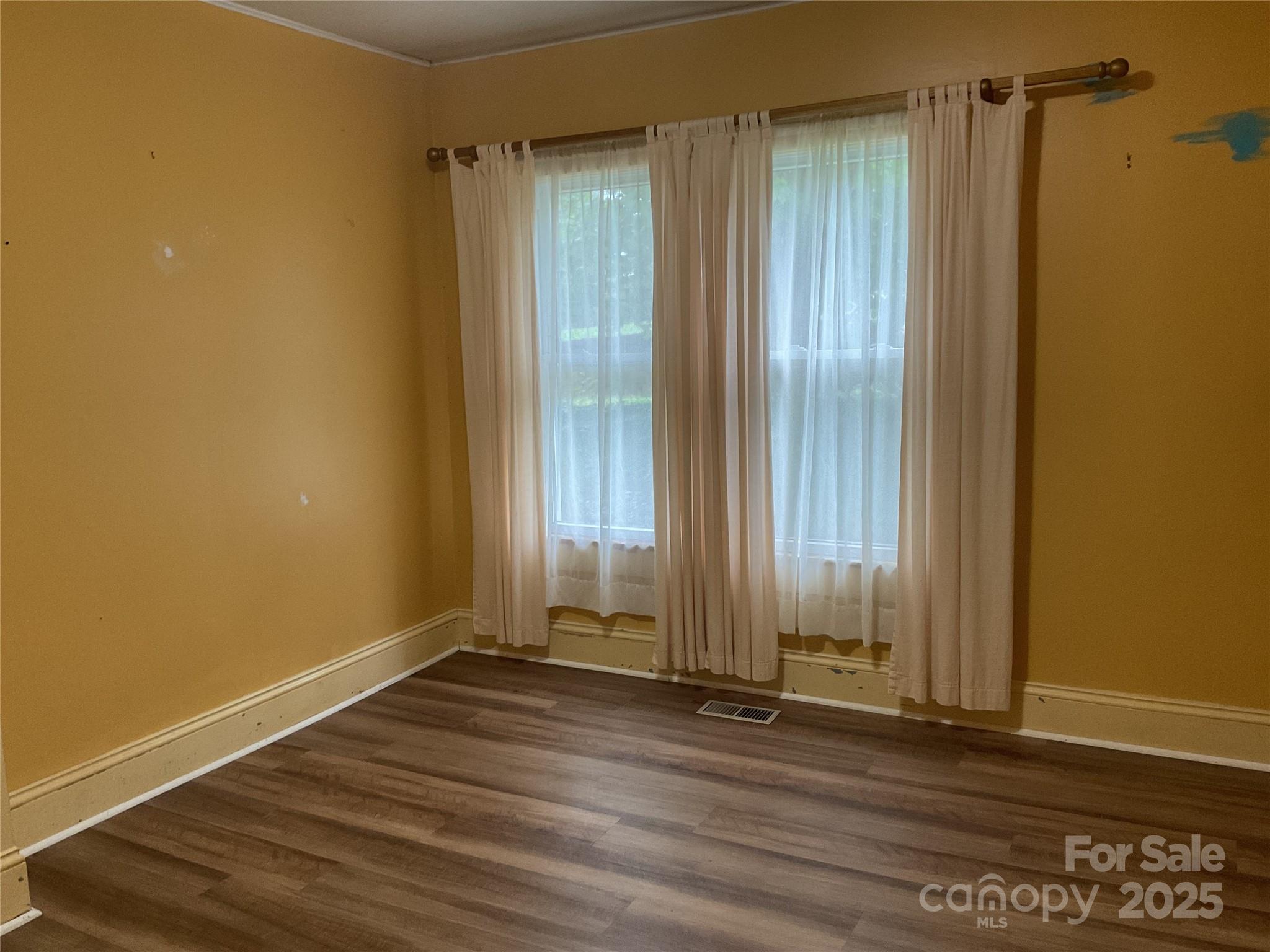 402 Connelly Springs Road Lenoir, NC 28645 - Photo 20 of 33 a view of a room with wooden floor and a window