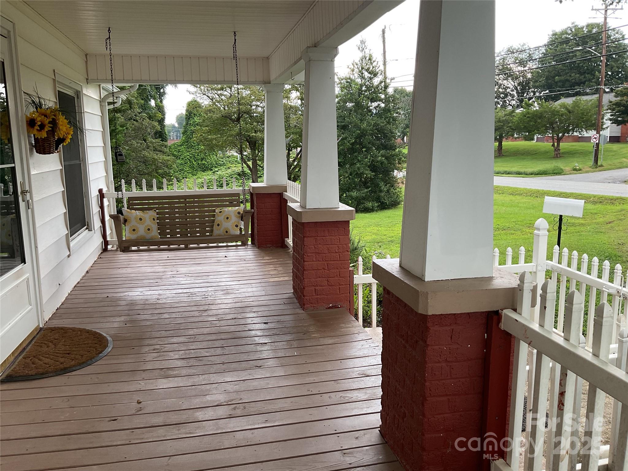 402 Connelly Springs Road Lenoir, NC 28645 - Photo 4 of 33 a view of a porch with wooden floor and outdoor space
