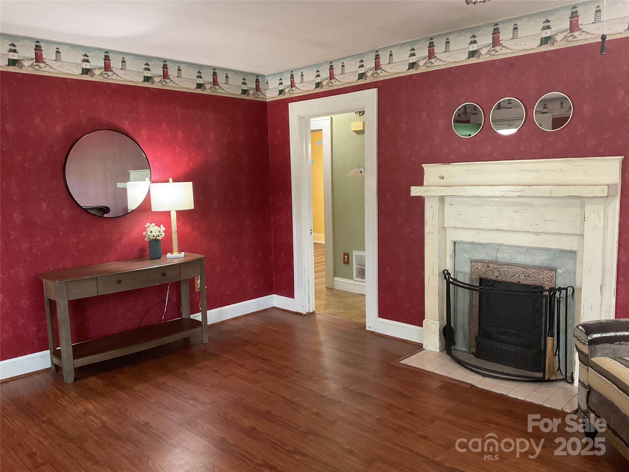 402 Connelly Springs Road Lenoir, NC 28645 - Photo 7 of 33 a view of a livingroom with furniture wooden floor a fireplace