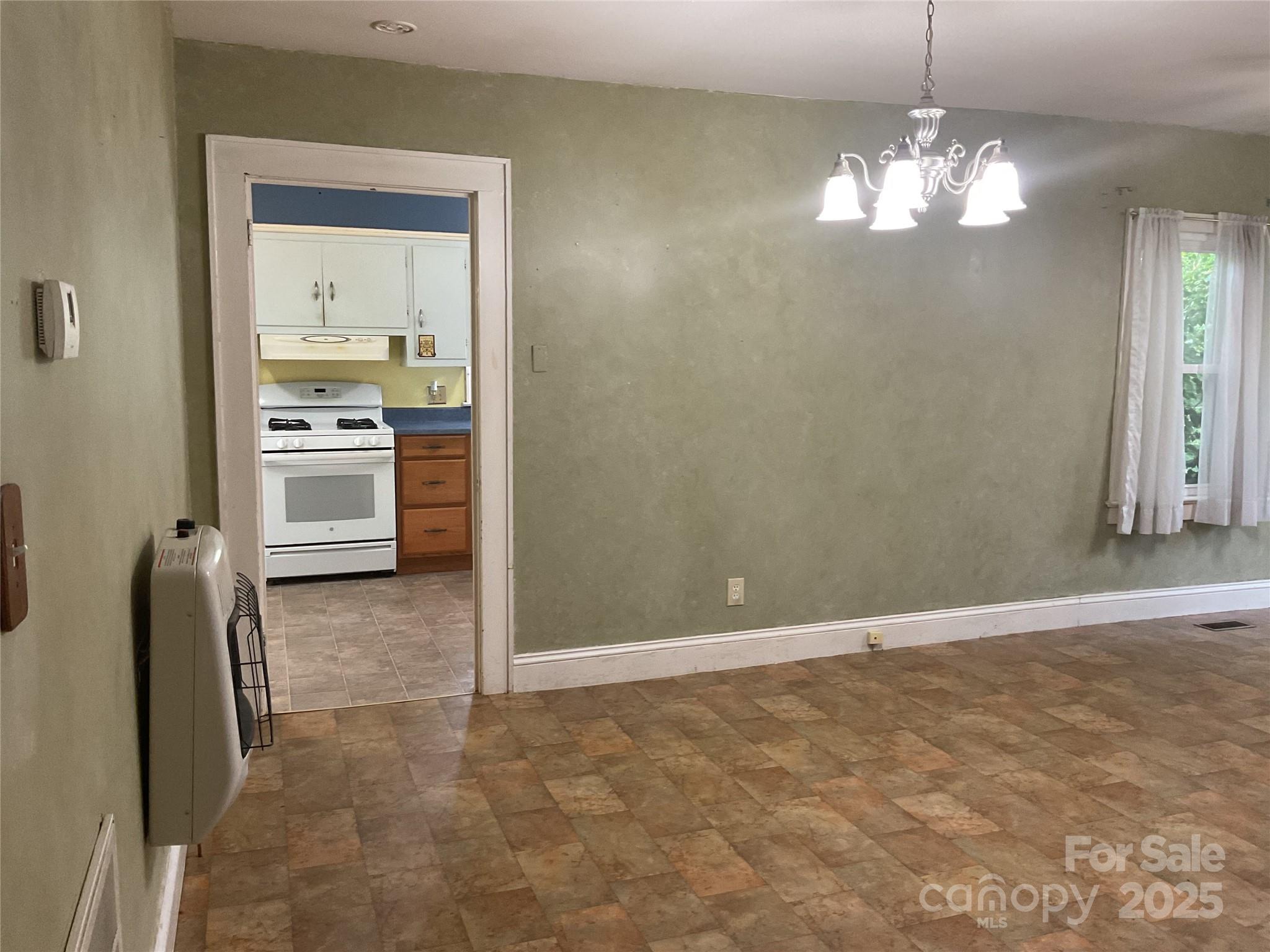 402 Connelly Springs Road Lenoir, NC 28645 - Photo 10 of 33 a view of a kitchen with a sink dishwasher and a refrigerator