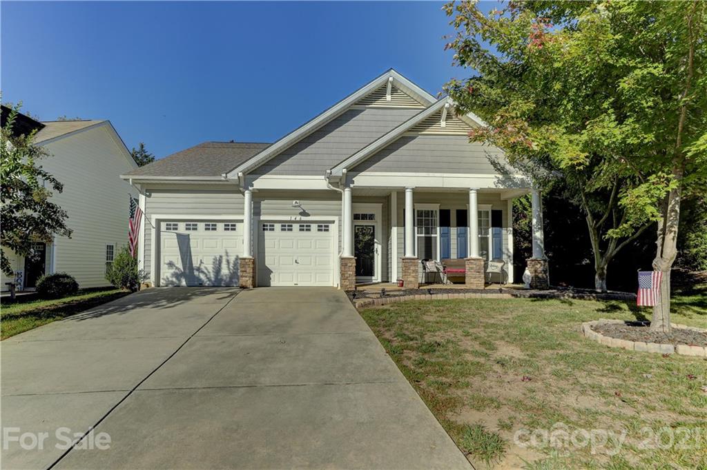 146 Whitley Mills Road Fort Mill, SC 29708 - Photo 2 of 37 a front view of a house with a garden and trees