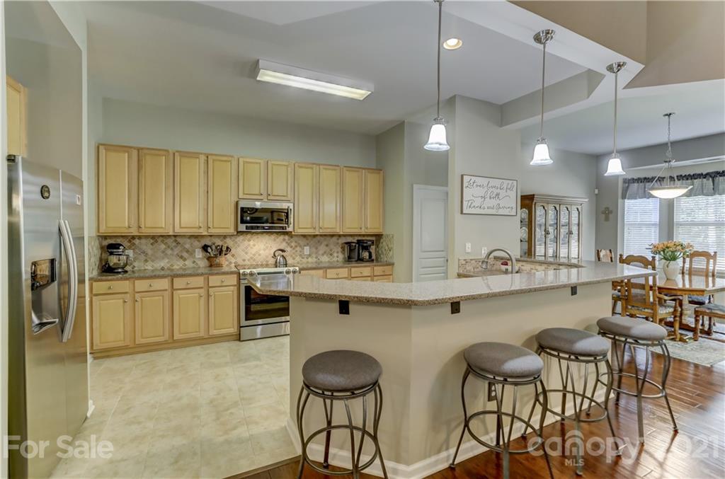 146 Whitley Mills Road Fort Mill, SC 29708 - Photo 11 of 37 a kitchen with white cabinets and stainless steel appliances