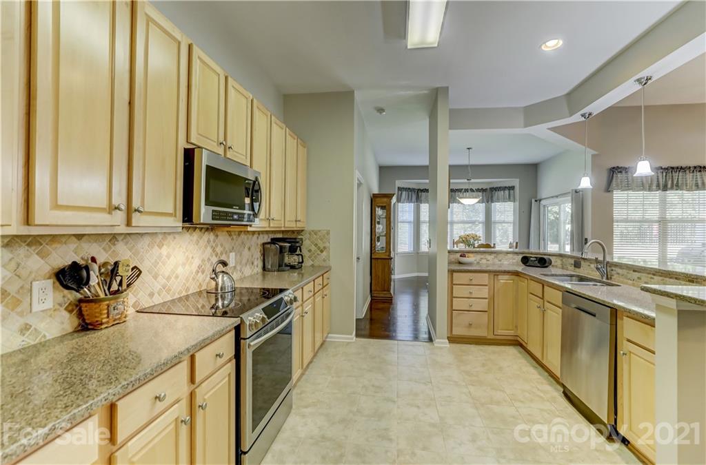 146 Whitley Mills Road Fort Mill, SC 29708 - Photo 12 of 37 a kitchen with stainless steel appliances granite countertop a sink and cabinets