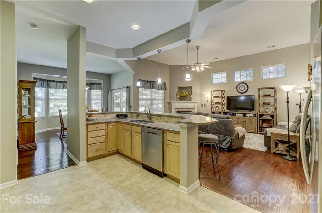 146 Whitley Mills Road Fort Mill, SC 29708 - Photo 13 of 37 a large white kitchen with lots of counter space dining table and stainless steel appliances