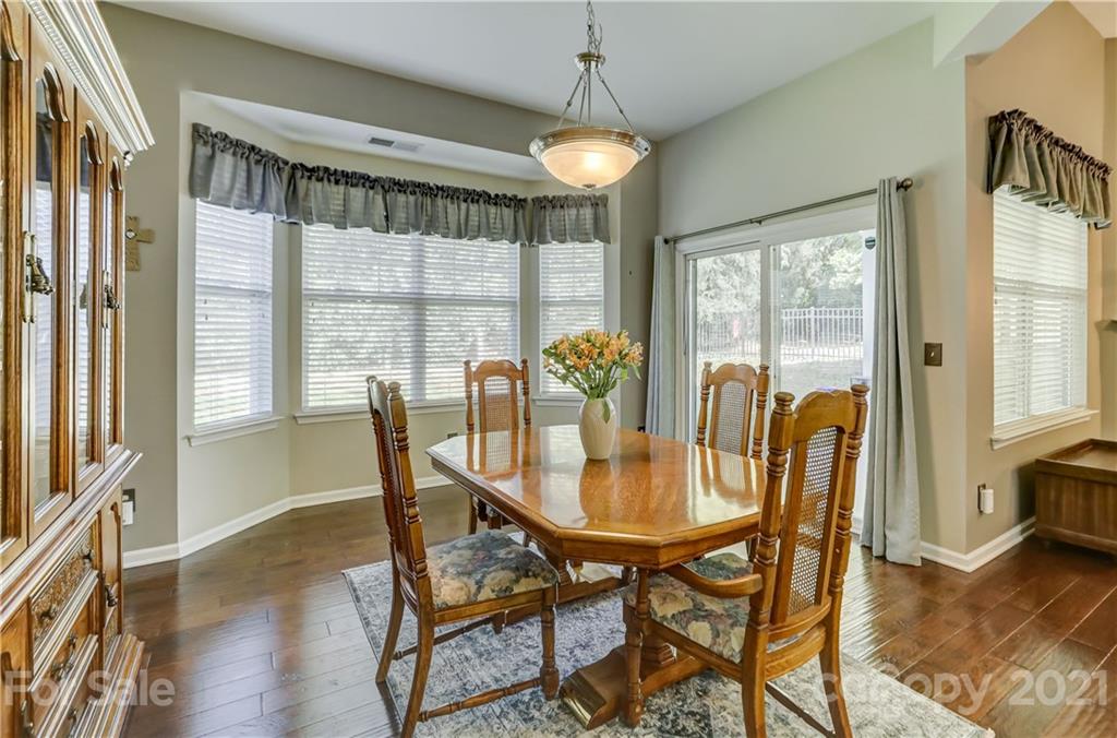 146 Whitley Mills Road Fort Mill, SC 29708 - Photo 16 of 37 a view of a dining room with furniture window and wooden floor