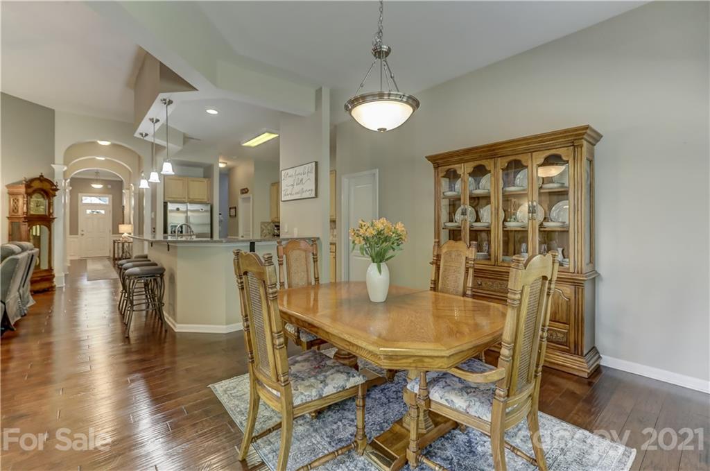 146 Whitley Mills Road Fort Mill, SC 29708 - Photo 17 of 37 a view of a dining room with furniture and wooden floor