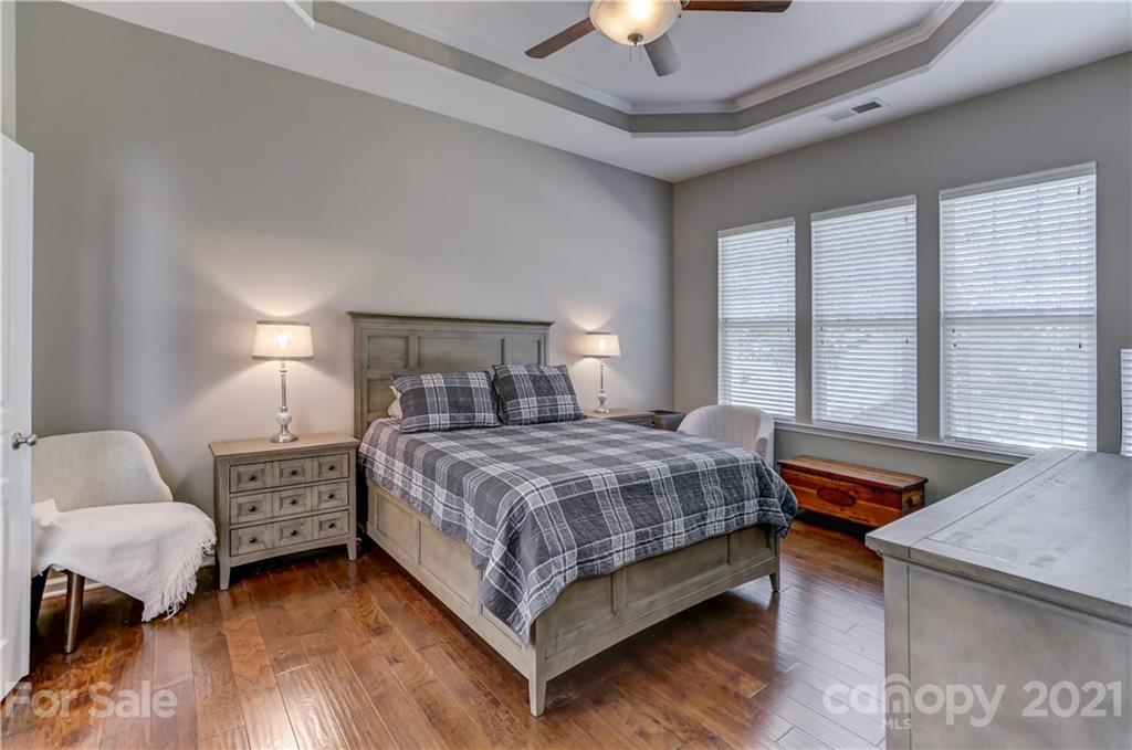 146 Whitley Mills Road Fort Mill, SC 29708 - Photo 19 of 37 a bedroom with a bed and a chandelier