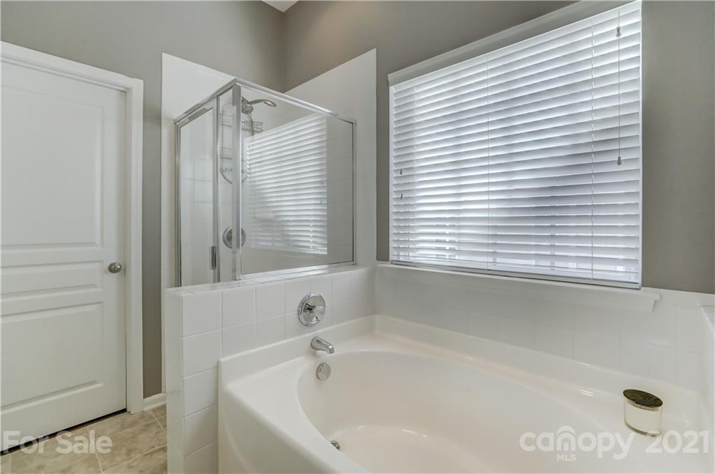 146 Whitley Mills Road Fort Mill, SC 29708 - Photo 21 of 37 a white bath tub sitting next to a window