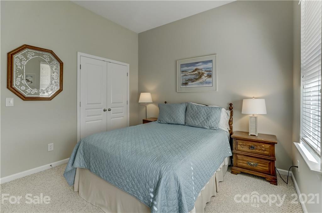 146 Whitley Mills Road Fort Mill, SC 29708 - Photo 25 of 37 a spacious bedroom with a bed a wall painting on the wall and a window