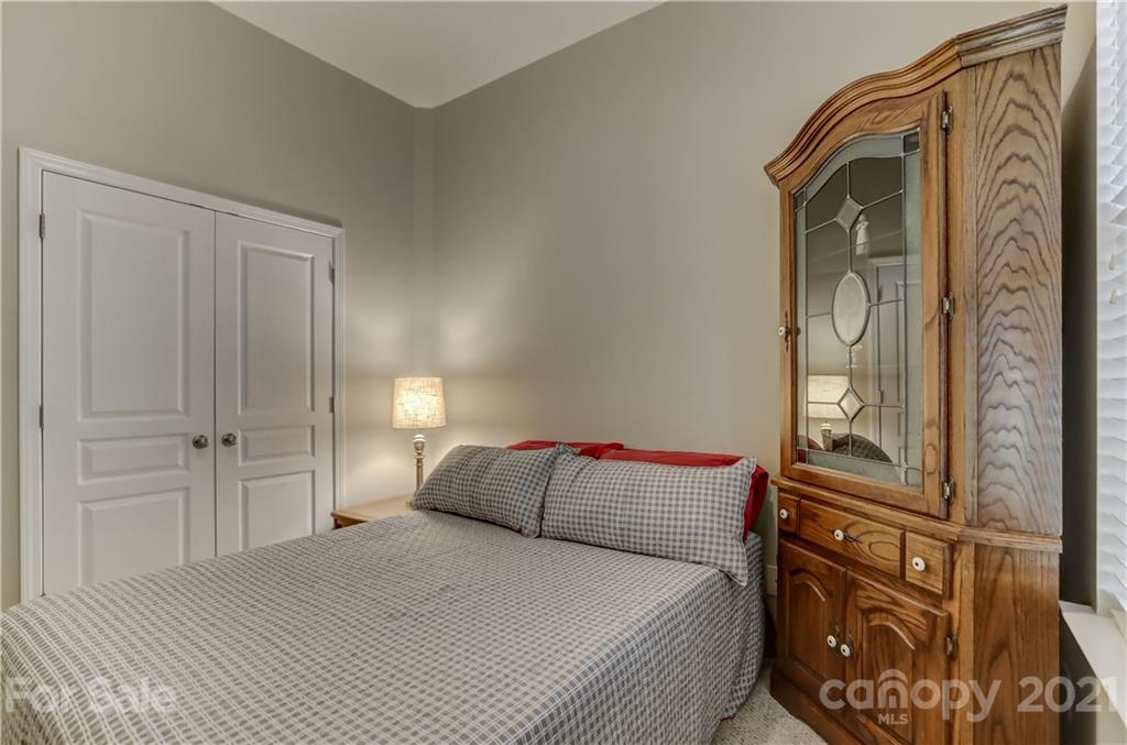 146 Whitley Mills Road Fort Mill, SC 29708 - Photo 28 of 37 a bedroom with a bed and a closet with mirror