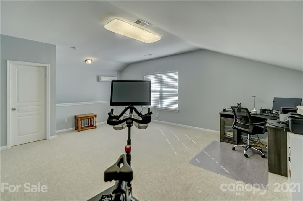 146 Whitley Mills Road Fort Mill, SC 29708 - Photo 29 of 37 a room with gym equipment and a flat screen tv