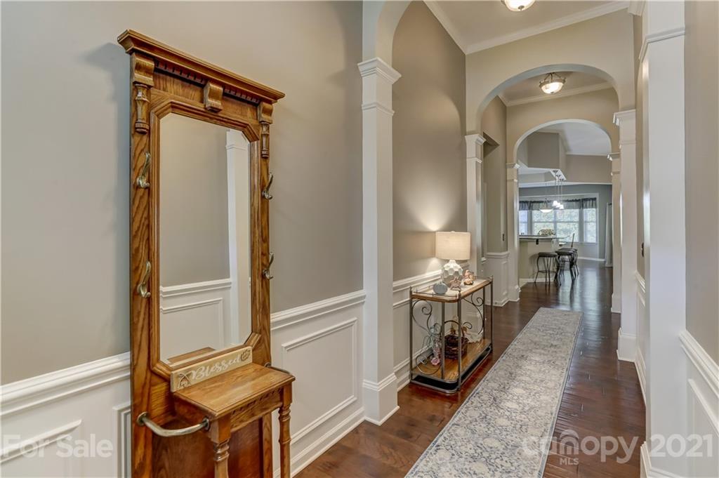 146 Whitley Mills Road Fort Mill, SC 29708 - Photo 7 of 37 a view of a hallway with a livingroom and a mirror